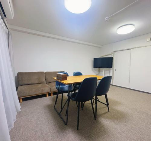 a room with a table and chairs and a couch at LoveTokyo Easy Access Nezu Sunset House 根津駅徒歩1分 エレベーター 上野 谷中銀座 根津神社 東京大学 新宿 渋谷 銀座 築地 原宿近い in Tokyo