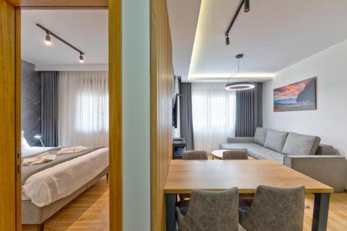 a living room with a bed and a dining table at Apartman Vida Zlatibor in Zlatibor