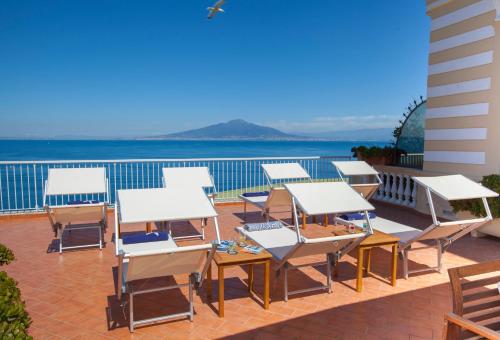 a row of tables and chairs on a patio at La Terrazza De Luxe in Sorrento