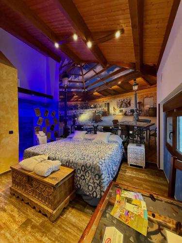 a bedroom with a large bed and a table at Hotel SPA El Lagar de Isilla in La Vid y Barrios