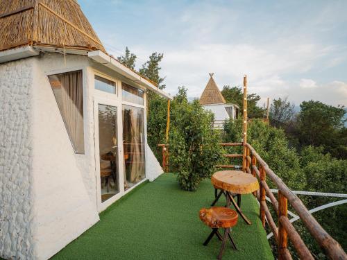 a balcony of a house with green grass at Pik Talgar Eco Village in Talghar