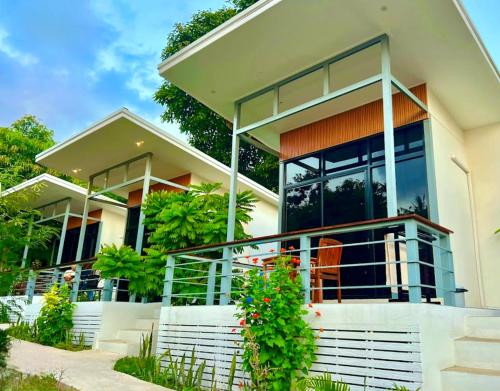 a house with large glass windows and a balcony at Modern Bungalows in Ko Chang