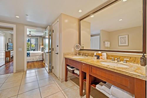 a bathroom with a sink and a large mirror at Honua Kai Konea 206 in Lahaina