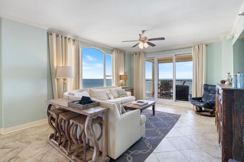 a living room with a couch and a table at Beach Colony Tower 7A By Pkrm in Pensacola