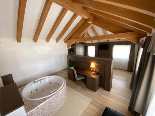 a large bathroom with a tub in a attic at Grand Hotel Miramonti in Passo del Tonale