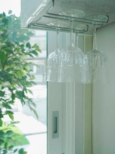 a bunch of wine glasses hanging from a ceiling at 부산 광안리 B&B stay in Busan