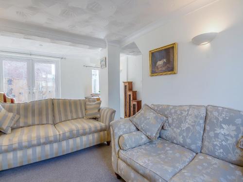a living room with two couches and a couch at Ravensmere Villa in Beccles