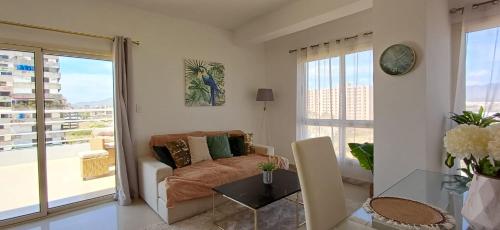 een woonkamer met een bank en een glazen tafel bij Chillis Penthouse in Porlamar