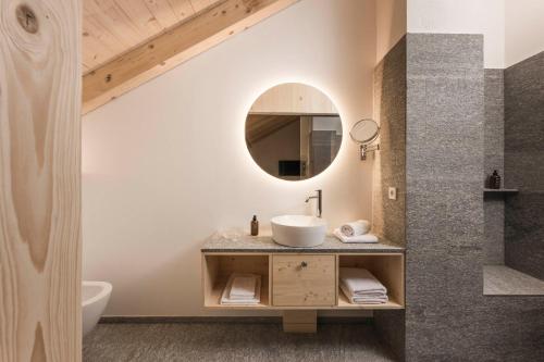 a bathroom with a sink and a mirror at Zalnerhof Urlaub am Bauernhof in Luson