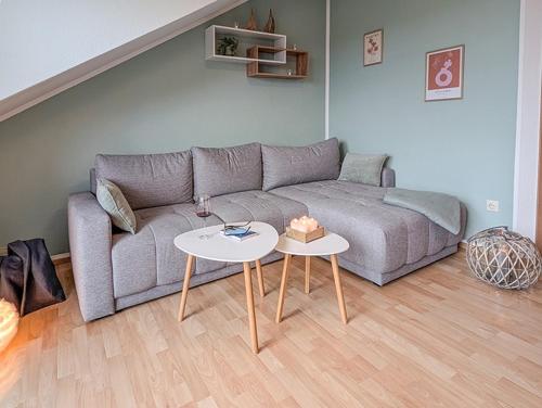 a living room with a couch and a table at Refugium - Möhneseeblick in Möhnesee