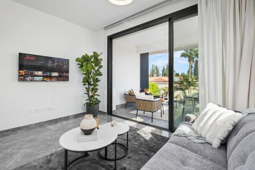 a living room with a couch and a table at Noir Luxury Residences by Nomads in Limassol