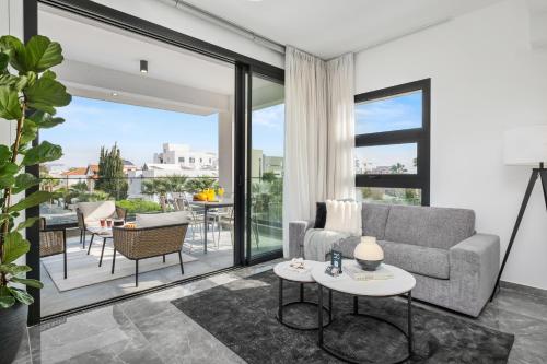 a living room with a couch and a table at Noir Luxury Residences by Nomads in Limassol