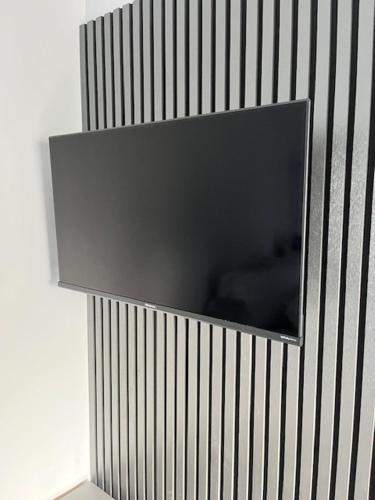 a corner of a wall with a television on it at The Stadium Hotel Anfield in Liverpool