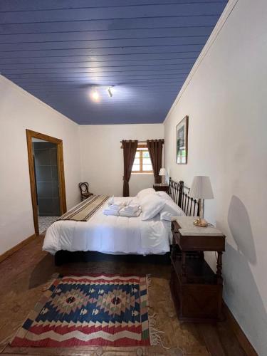 a bedroom with a large bed and a table at Hacienda Ranguil in Lolol