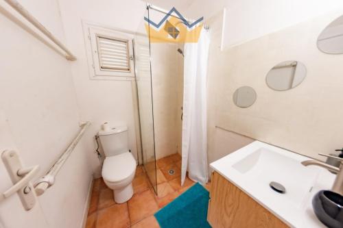 a bathroom with a toilet and a sink at La Villa du soleil in Les Trois-Îlets