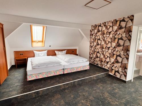 a bedroom with a bed and a pile of fire wood at Hotel Garni Eschenbach in Hildburghausen