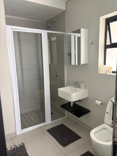a bathroom with a shower and a sink at Flat 4 Block 12 Bellamare in Port Elizabeth