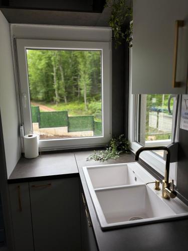 a kitchen with a sink and a window at Villa Tea - Private Pool Villa, Slatina in Laktaši