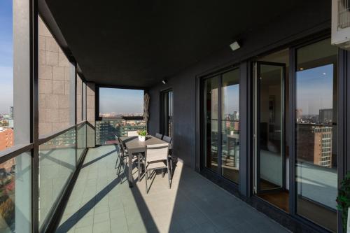 a balcony with a table and chairs on a building at Settimo Cielo - San Cristoforo in Milan