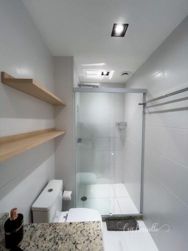 a bathroom with a glass shower and a toilet at Skylux By Cris Borriello in Rio de Janeiro