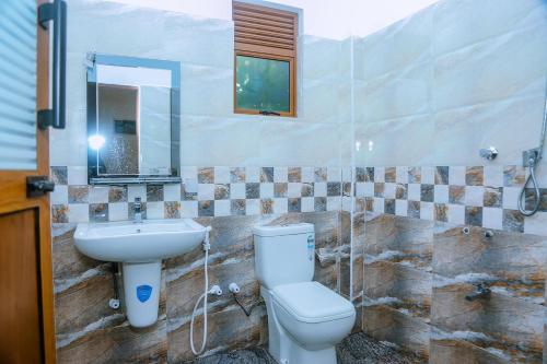a bathroom with a toilet and a sink at Cozy 1BR Villa in Weligama Panoramic Sea View in Weligama