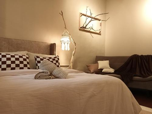 a bedroom with a large bed and a couch at Senju Georgetown Heritage PrewarHouse 4BR 5-15 pax in George Town