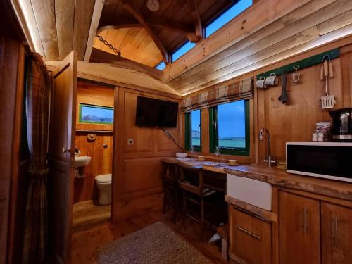 a kitchen with a sink and a counter in a train at The Loft Glamping & Camping in Kinloss