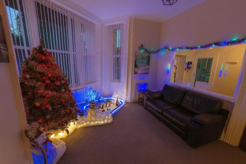 uma sala de estar com uma árvore de natal e um sofá em Cecil Court Hotel em Bournemouth