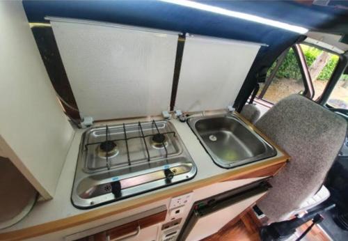 a kitchen with a stove and a sink at Retro Camper Hire in Dublin