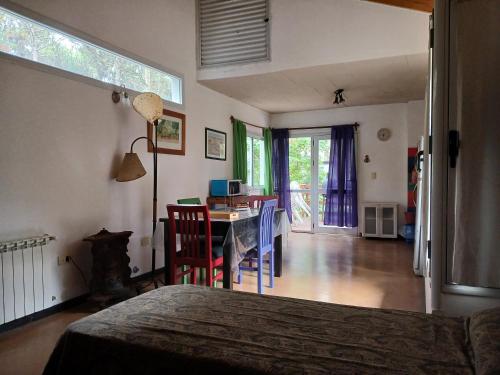 a bedroom with a bed and a table and chairs at La casa de los Abuelos in Costa del Este