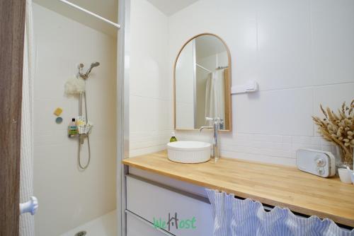 a bathroom with a sink and a mirror at Orves - Seine-Saint-Denis - CI - Elegance and comfort with garden for 2 people in Le Pré-Saint-Gervais