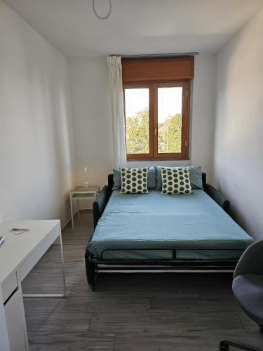 a bedroom with a bed and a window at Luca Apartment Rho in Rho