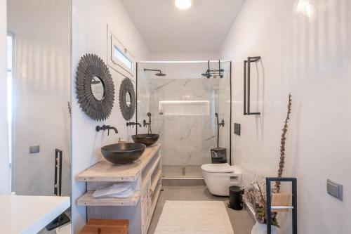 a bathroom with a sink and a toilet and a shower at 3 Paros All Season Villas in Parikia