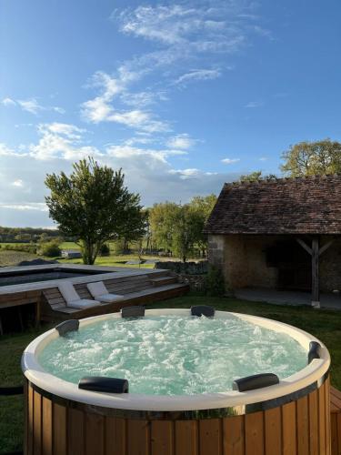 a hot tub in the middle of a yard at Domaine Le Pineau Private Pool & Nordic Jacuzzi Loire Valley in Bléré