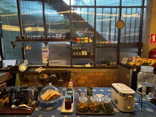 a kitchen with a table with food on it at บ้านระเบียงดอยโฮมสเตย์ in Ban Pok Nai