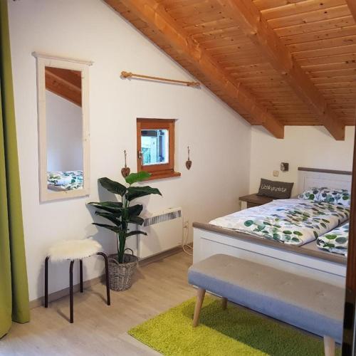a bedroom with a bed and a potted plant at Ferienhaus Walter im Waldferiendorf in Regen