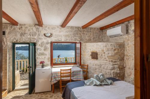 a bedroom with two beds and a balcony at Pansion Mali Raj in Goveđari