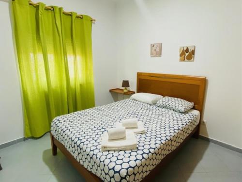 a bedroom with a bed with two towels on it at SwordFish Fortress View in Peniche