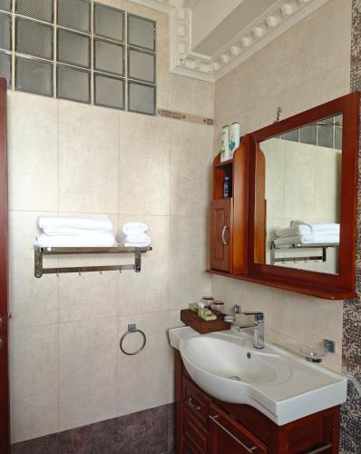 a bathroom with a sink and a mirror at Zawadi Apartment in Dar es Salaam