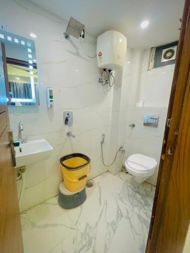 a bathroom with a toilet and a sink at Hotel Mount View Inn with terrace Ganga view- near Laxman jhula, Tapovan Rishikesh in Rishīkesh