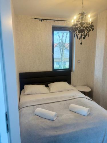 a bedroom with a large bed with two pillows on it at Hevenia Klifowa 5 B Apartament 33 in Rewal