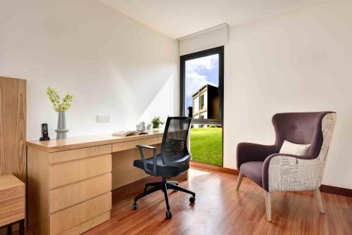 a home office with a desk and a chair at Lakeview Terrace Resort Pengerang in Pengerang