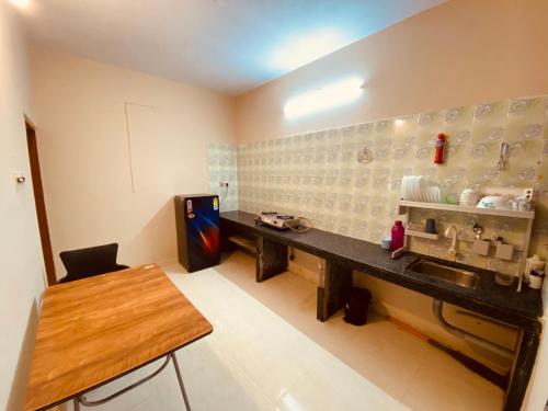 a kitchen with a counter and a sink in a room at AL MANAL K-002 Premium 2BHK Retreat in Bhatkal