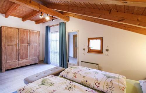 two beds in a room with wooden ceilings at Ferienhaus Alexandra in Regen