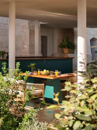 a patio with a table and chairs and plants at VISTA Ostuni in Ostuni