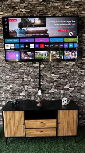 a flat screen tv hanging on a wall at Chalet Saint Lawrence GDL in Guadalajara