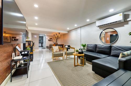a living room with a couch and a table at Bangkok Watergate Townhouse 曼谷中心水門家 in Bangkok