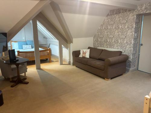 a living room with a couch and a piano at Windermere Park B&B inc Free off-site Health Club in Windermere