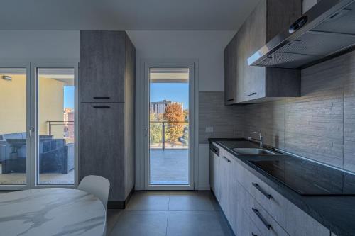 a kitchen with a sink and a large window at Casa Dalia in Garbagnate Milanese
