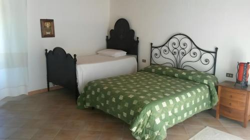 a bedroom with a bed and a bed sidx sidx sidx sidx at Stazzu Spadulagliu near Olbia in Telti